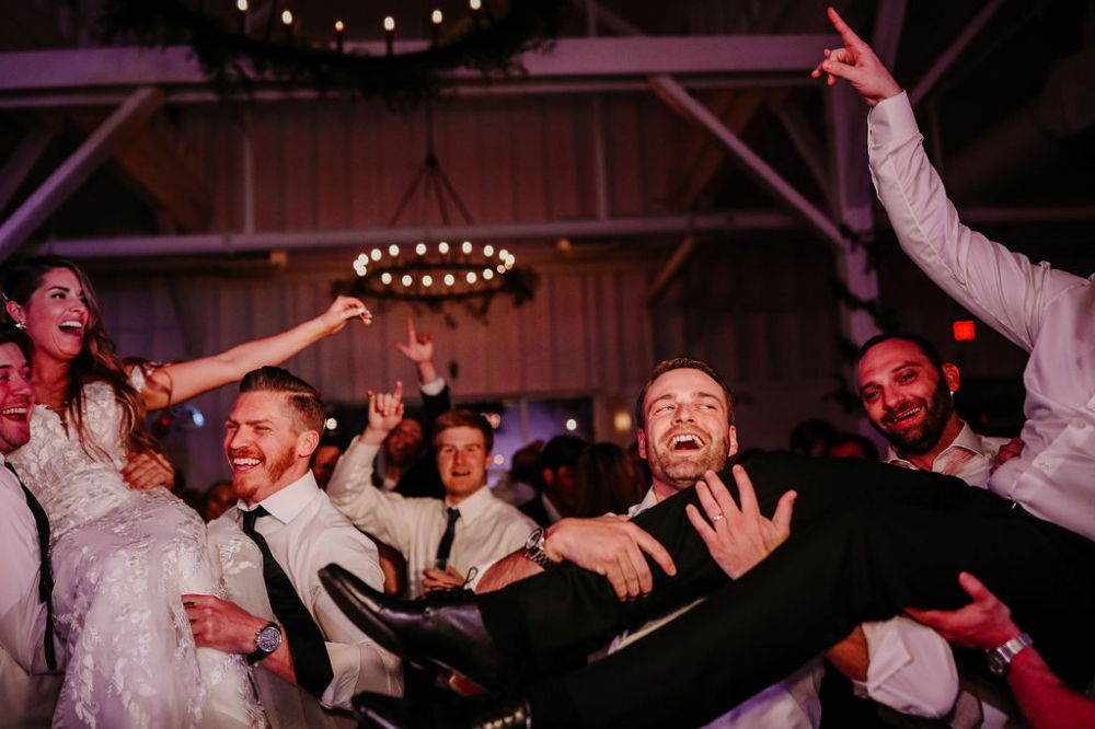 Guests lifting the bride and groom into the air during a hit song at 14TENN in Nashville, Tennessee