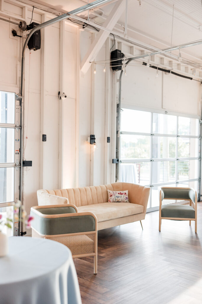 A wedding venue in Nashville featuring a pink couch and green chairs.