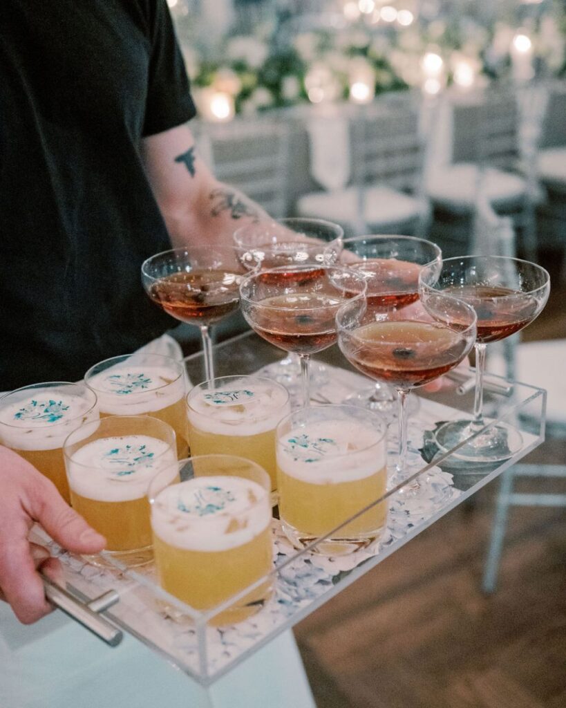 A tray of wedding cocktails are delivered to guests