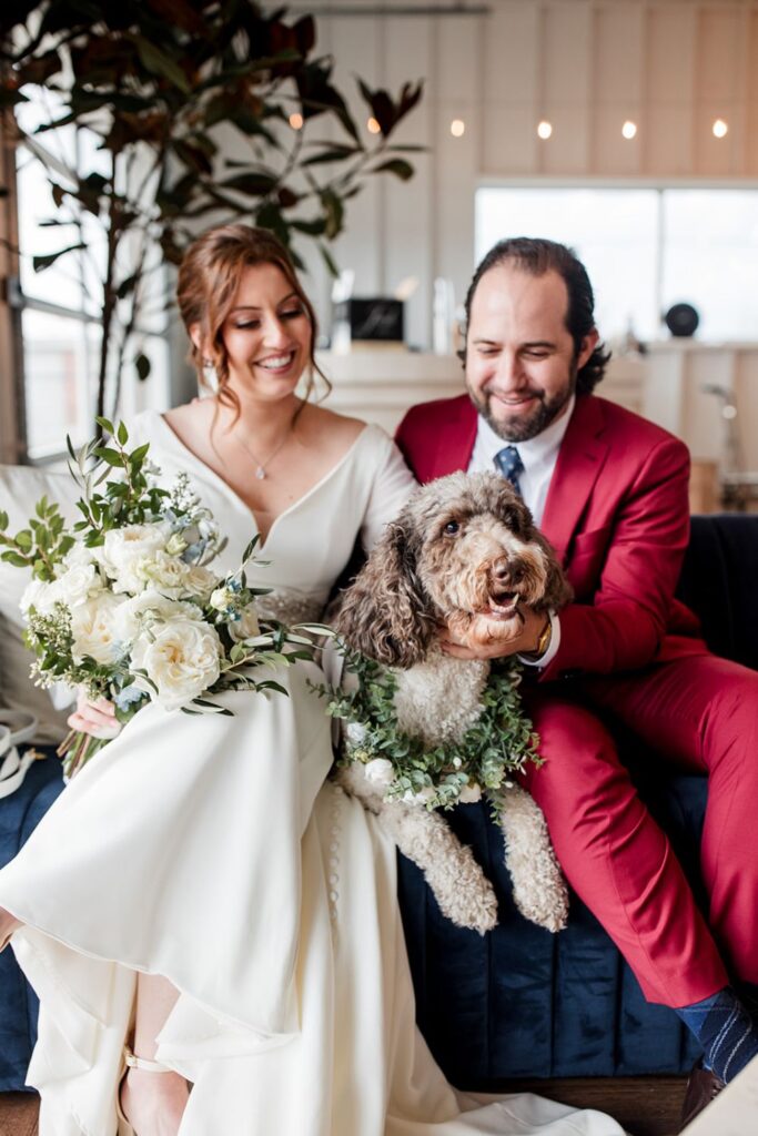 A bride and groom with their dog