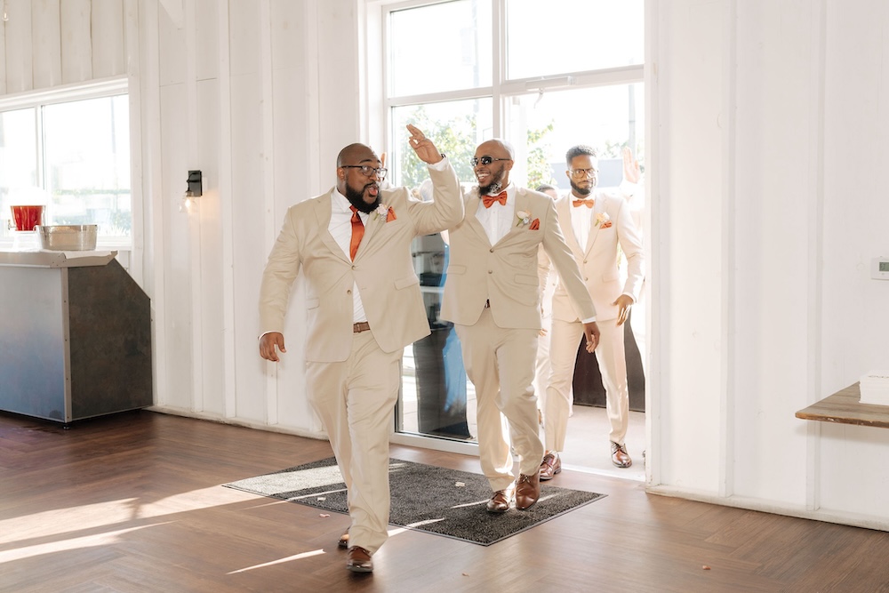 Groomsmen entering a wedding reception