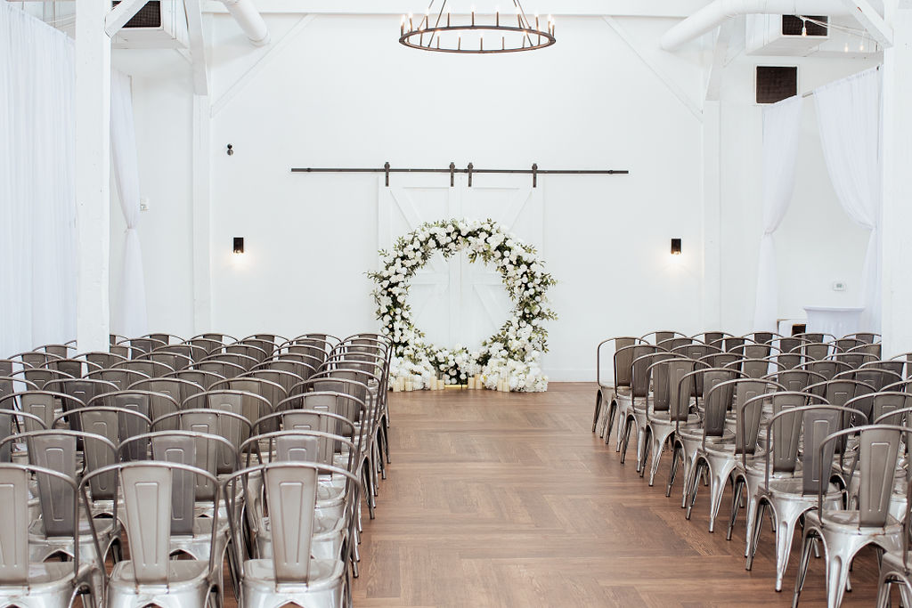 Wedding ceremony at 14TENN with large floral arch