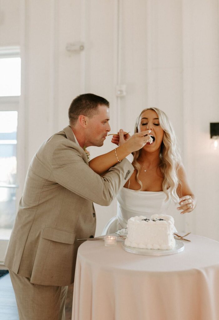 Bride and groom cutting wedding cake