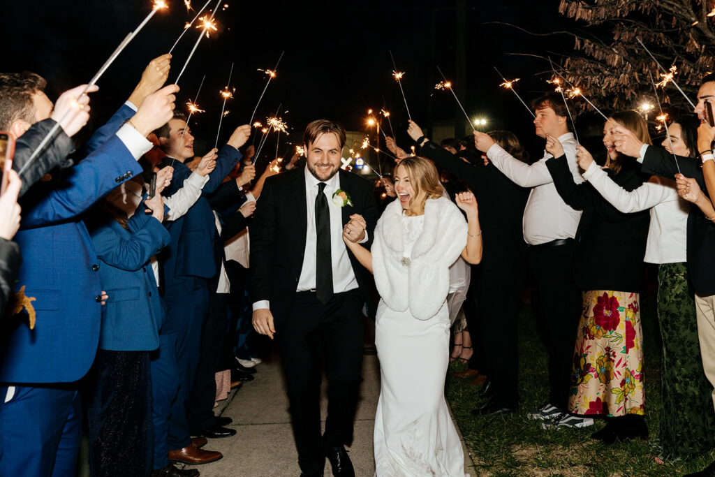 Bride and groom walking through their sparkler exit