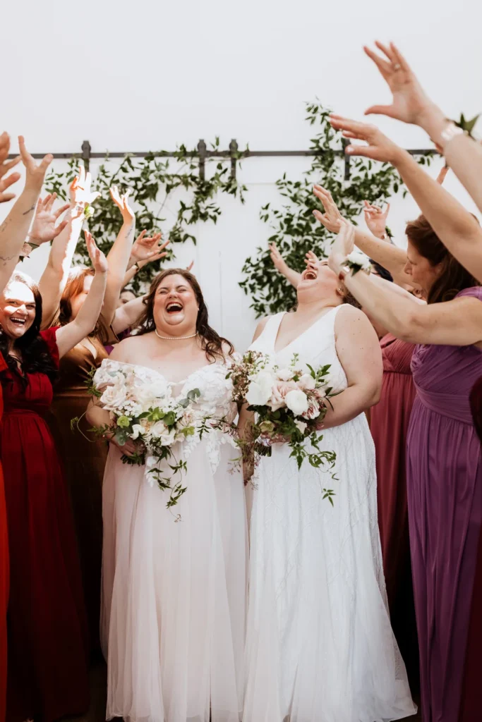 Brides and their bridal party cheering
