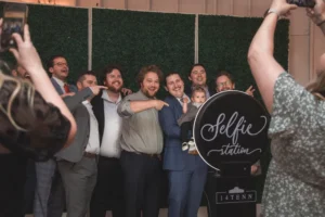 Wedding guests posing in front of photo booth
