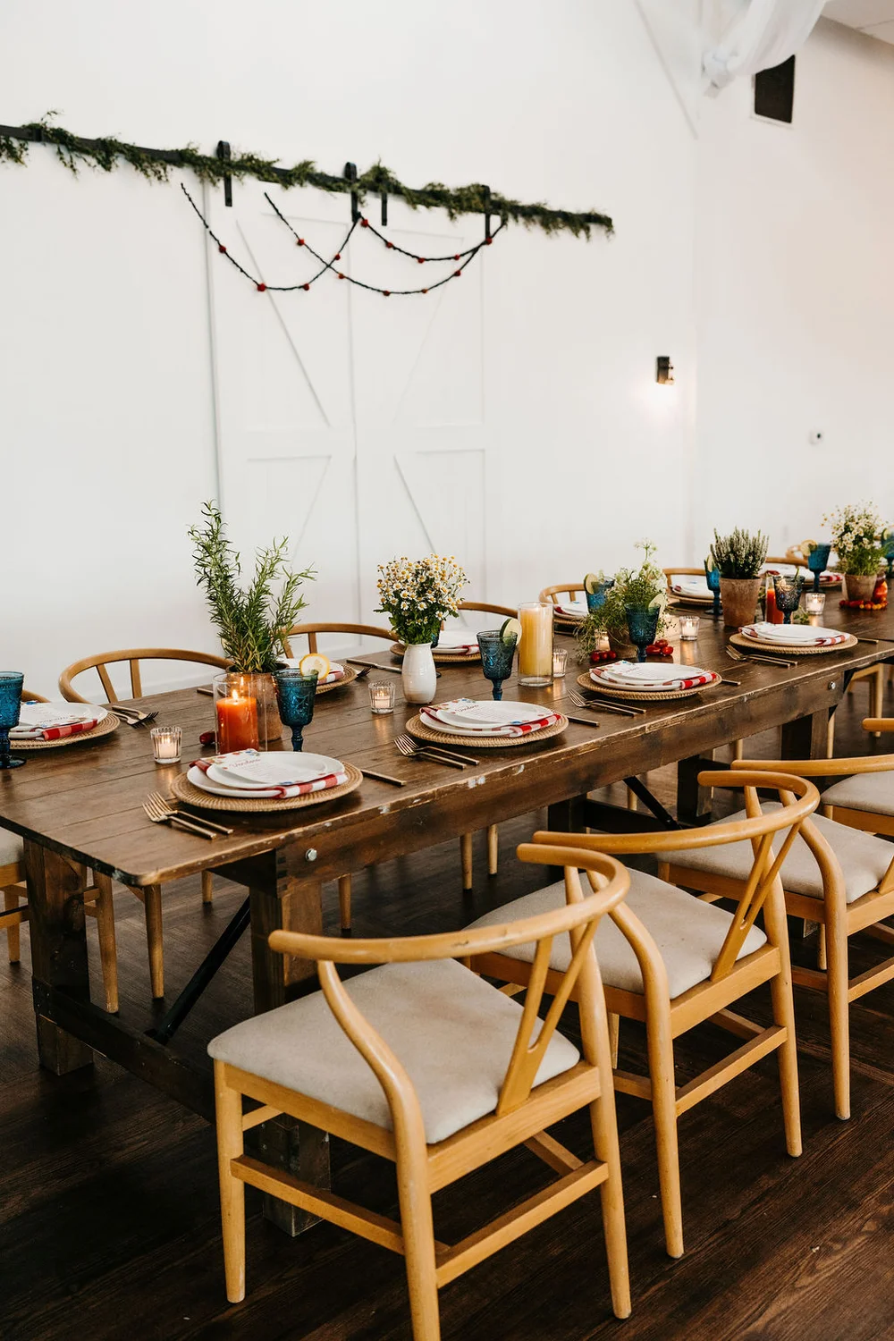 Nashville wedding tablescape details featuring colorful glassware, candles, and potted plants