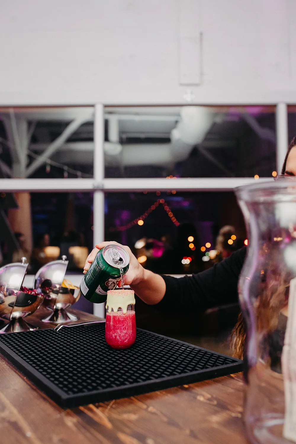 Bartender pouring a drink at a Nashville office holiday party at 14TENN.