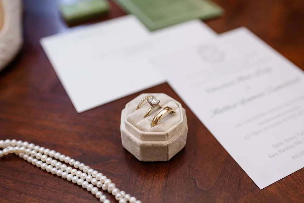 Wedding ring and invitation details styled for a modern wedding