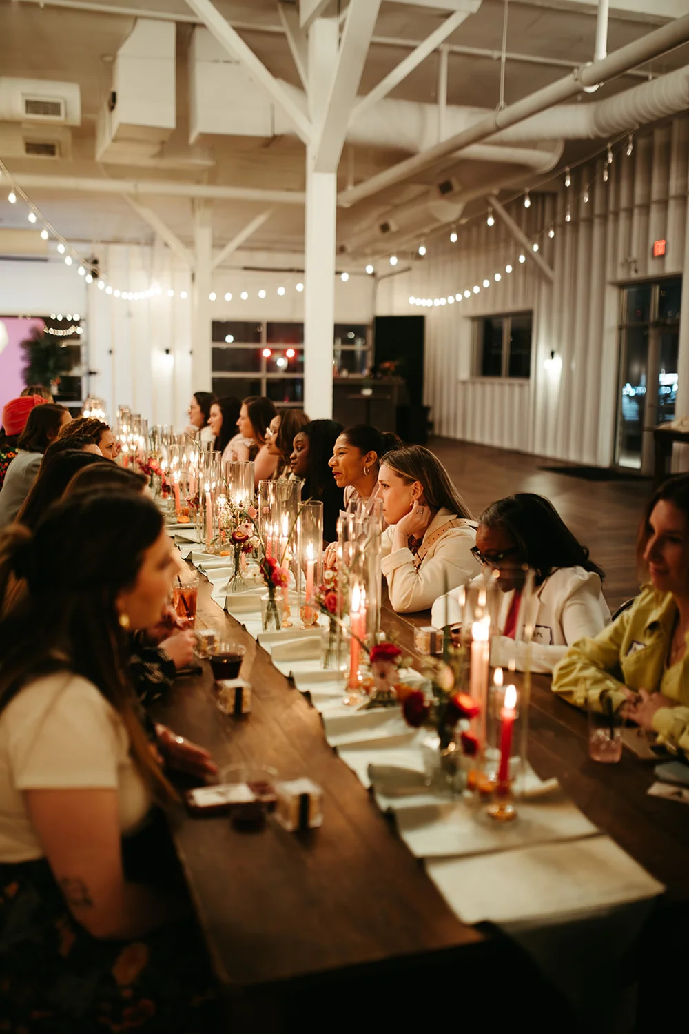Women networking at a family-style table during a wedding industry networking event at 14TENN Nashville